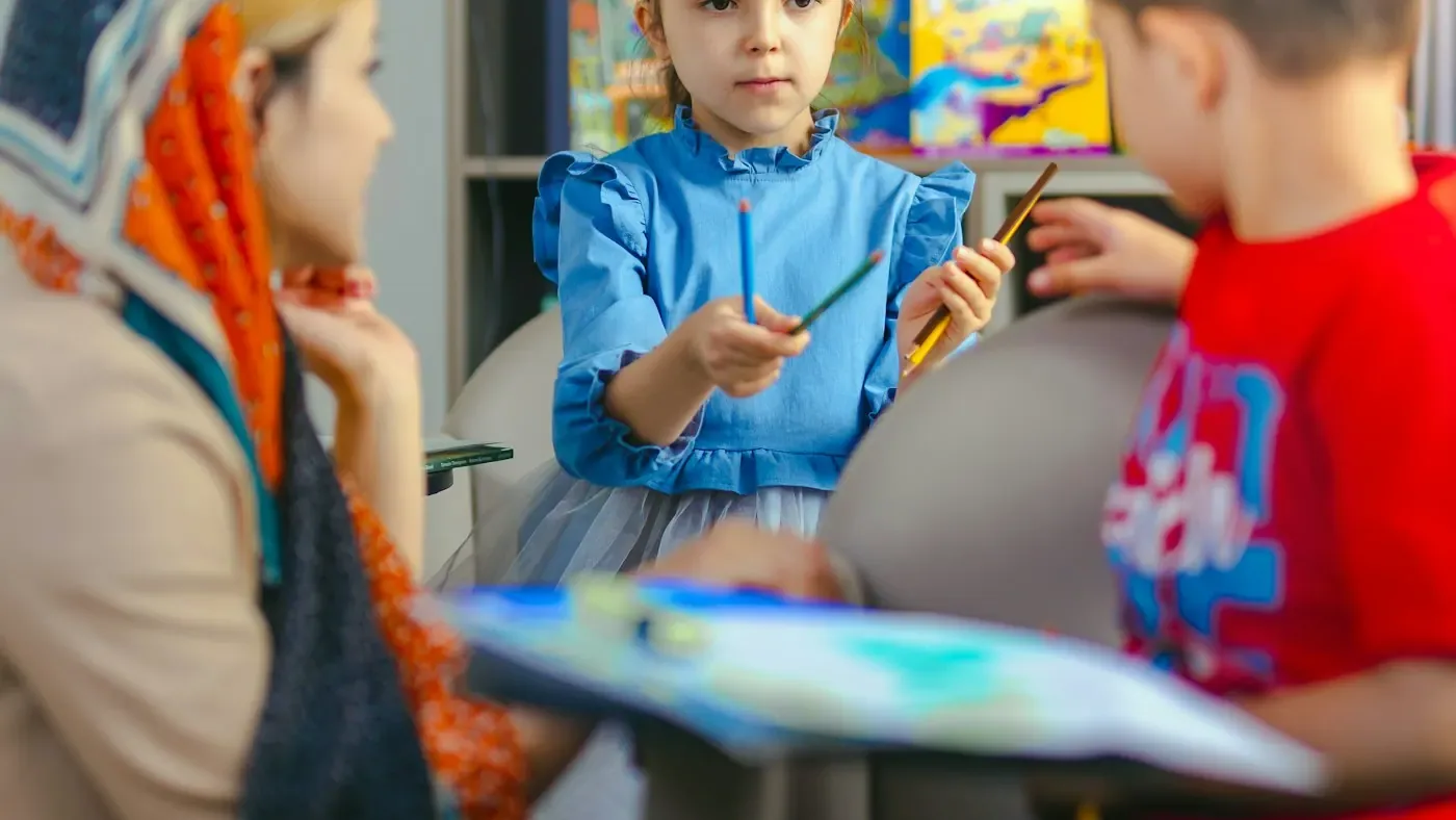 An adult and a child working together at a table.